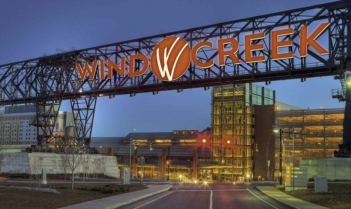 Wind Creek sign over a road with buildings in the background